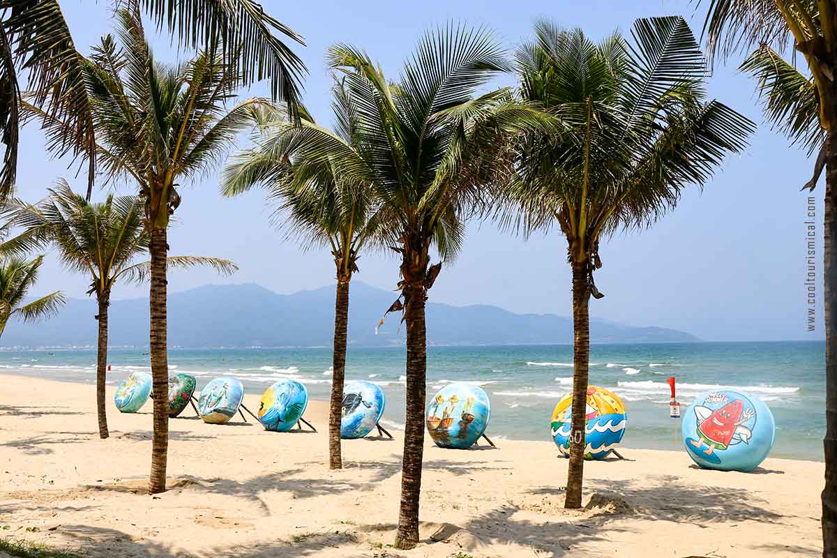 My An Beach in Da Nang with traditional row boats beautifully painted and palm trees.